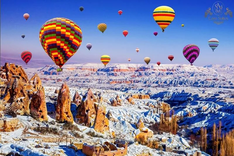 Cappadocia hot air balloons over a snowy landscape